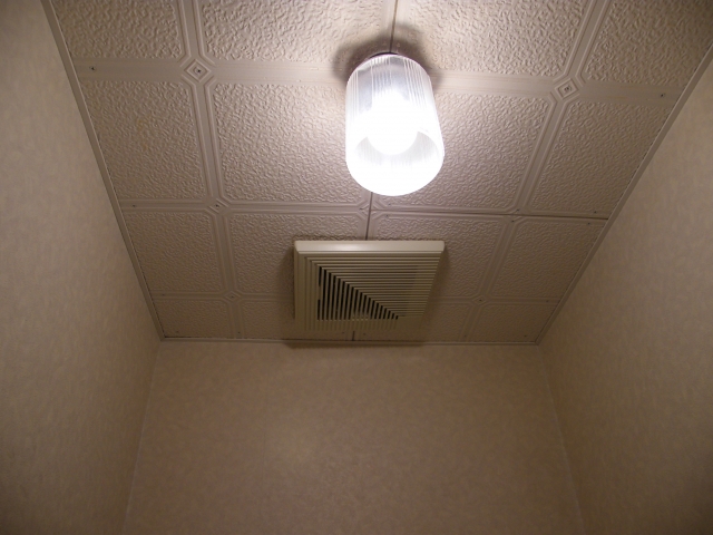 トイレの個室でオリエンティングをするイメージを、トイレの天井の画像で表現